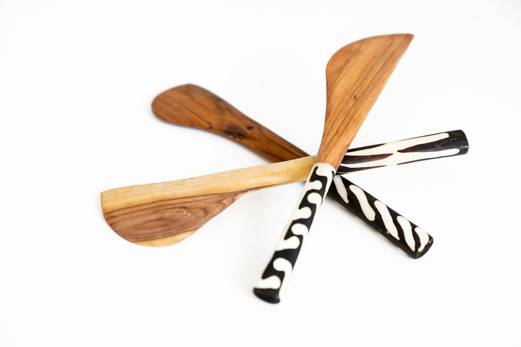 Handcrafted fair trade serving spoons made from sustainable wood, featuring smooth finishes and artisan detailing.