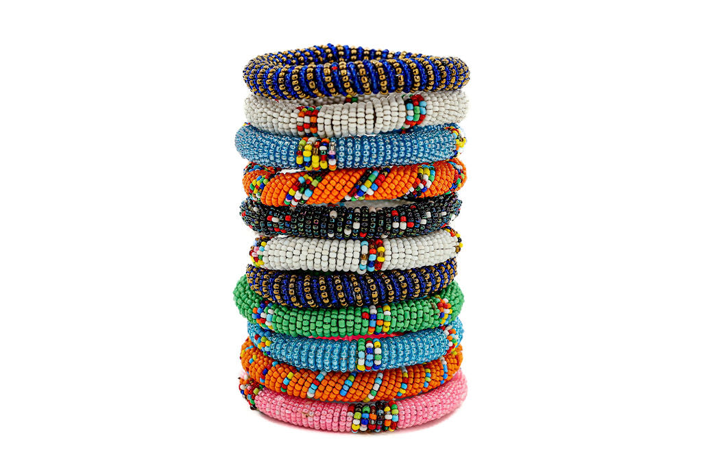 Colorful stack of fair trade beaded bracelets, handcrafted by artisans using traditional techniques and sustainable materials.