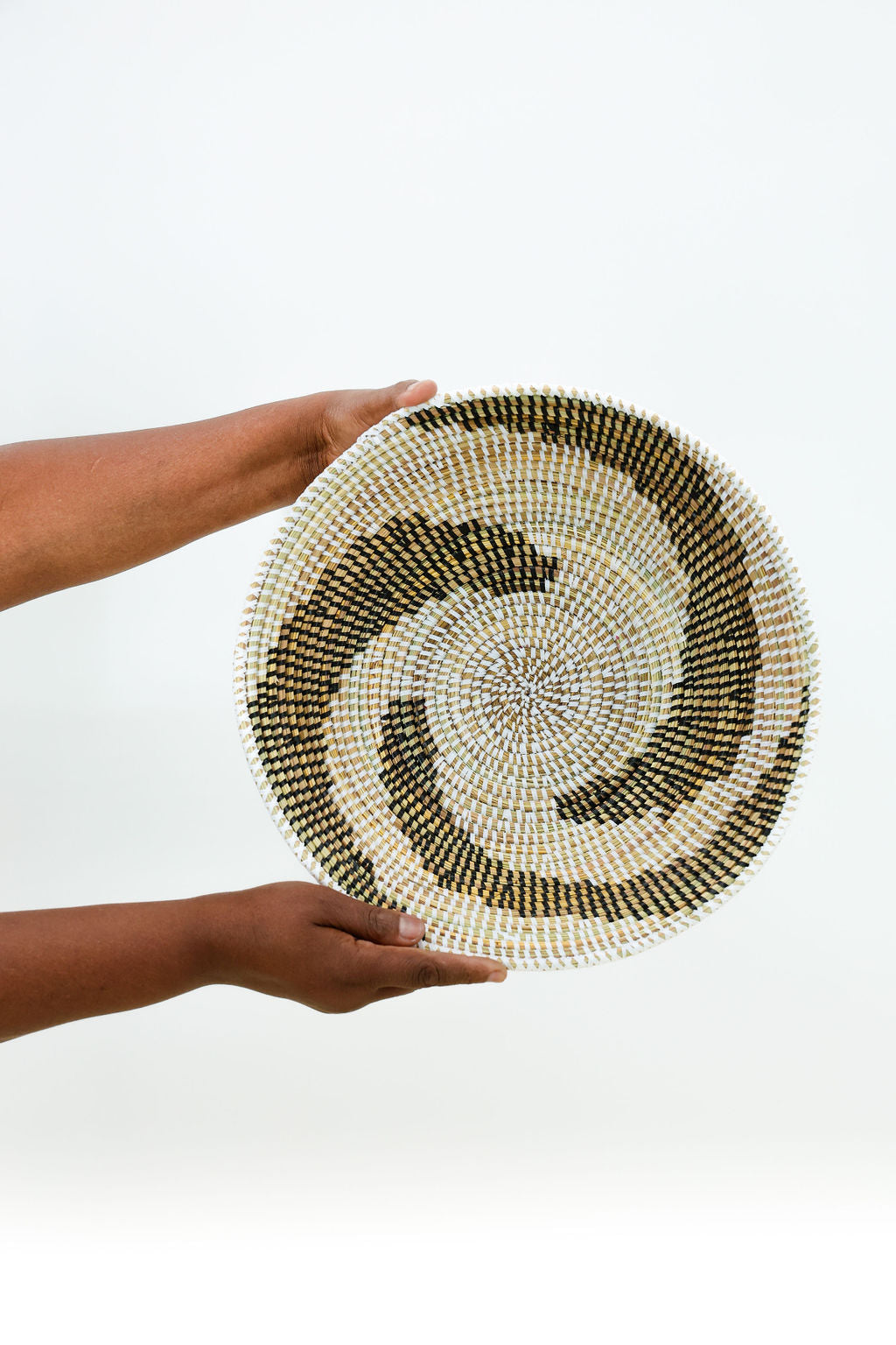 Handcrafted decorative bowl with hook for wall hanging, made from natural fibers showcasing intricate weaving and vibrant patterns.