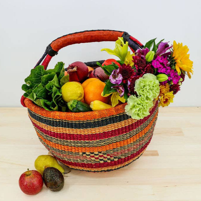 Fair trade African Market Basket handwoven from hand dyed Kinkanhe grass and has a leather handle.