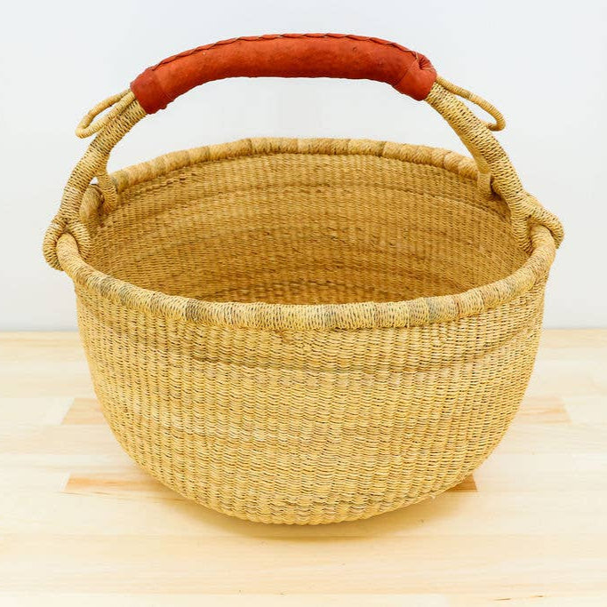 Natural fair trade market basket with single leather handle.