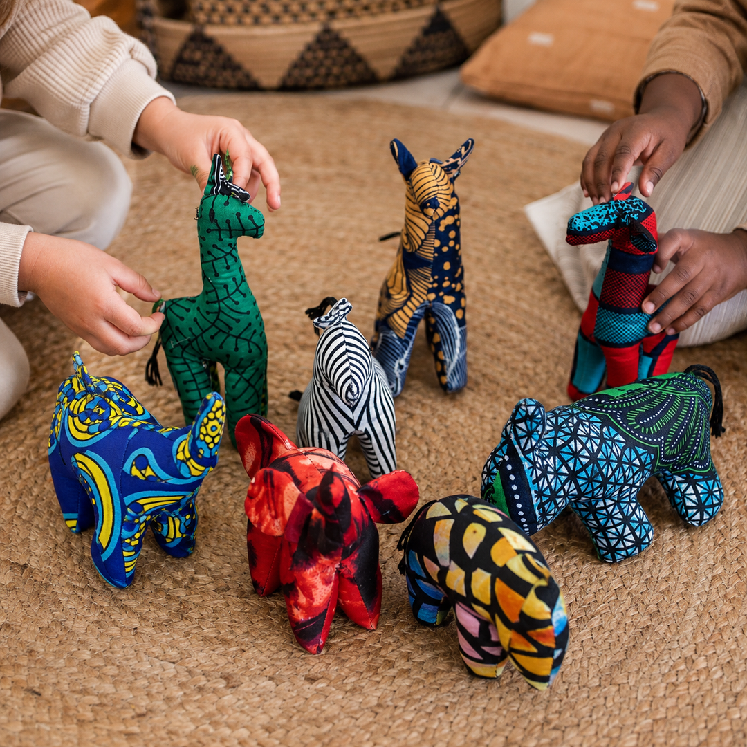 Kids playing with colorful fair trade stuffed animals handmade from African print fabrics.