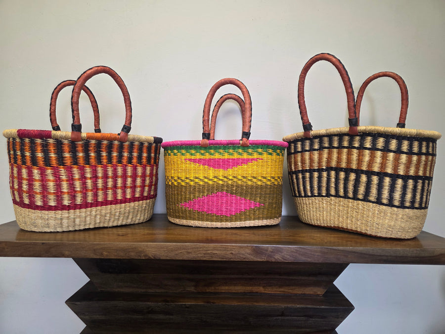 Three colorful Hand-woven oval baskets with leather handles. Great for a shopping at the farmer's market.