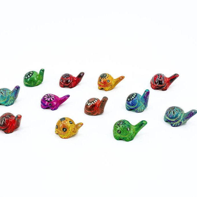 Assorted fair trade soapstone turtles from Kenya on white background.