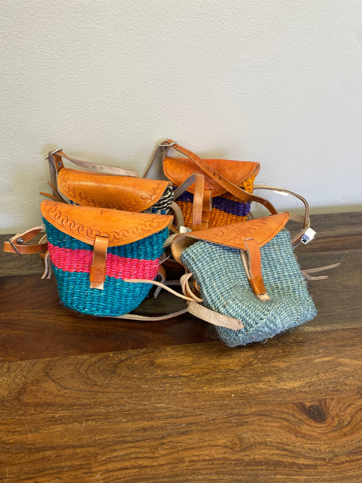 Artisan-woven baby size sisal purse with adjustable leather crossbody straps.