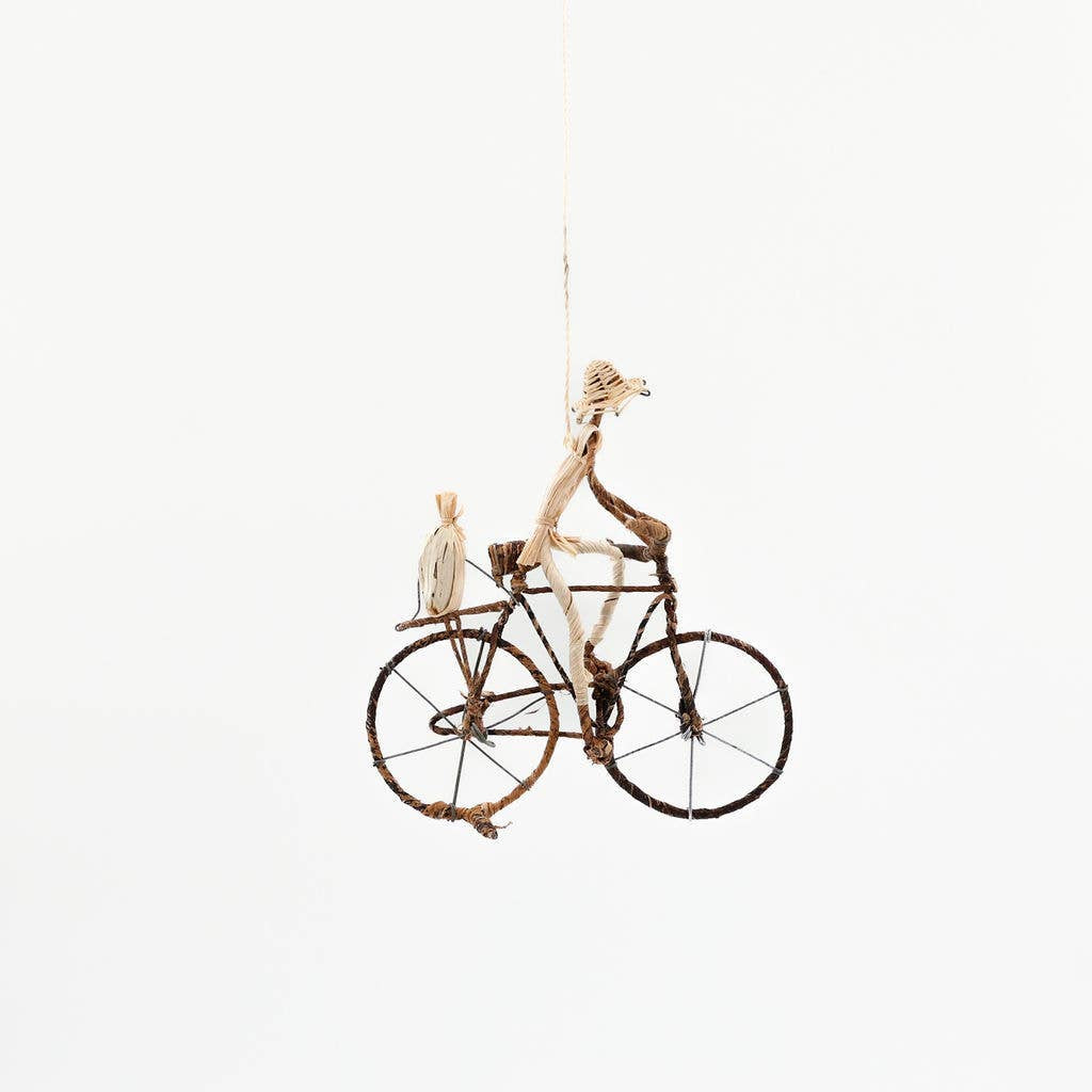 Fair trade banana leaf bicycle figurine handcrafted with metal wire frame, standing or hanging cyclist decor.