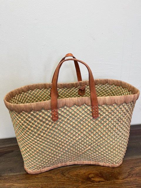 Beige tote blending perfectly with the sandy shores at the beach.