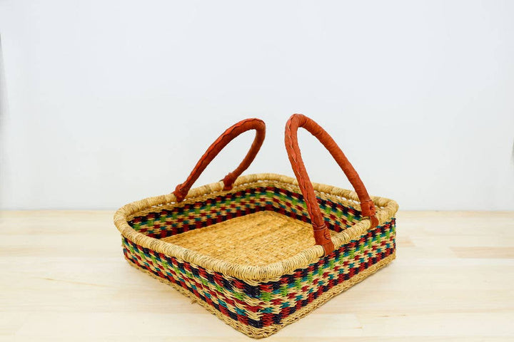 Eco-friendly fair trade elephant grass basket with leather handles, ideal for crafting, picnic, or home decor.