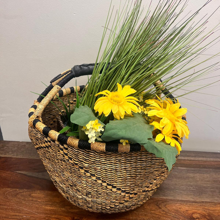 Black and natural bolga basket with flowers, perfect for the market and gifting. 