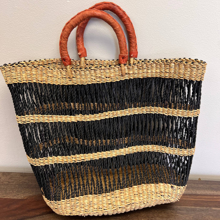 Fair trade black and tan vetiver grass market tote with intricate hand-dyed pattern.