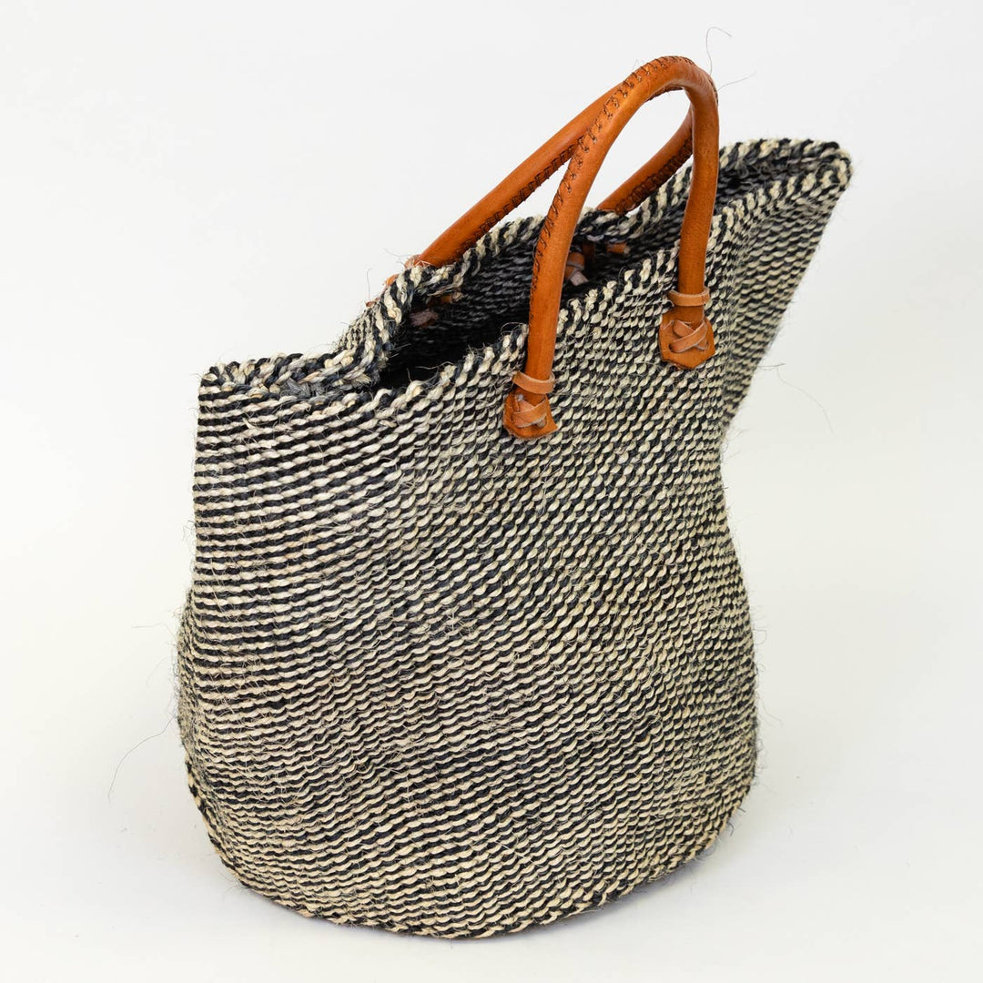Tibo sisal tote bag used as a beach bag with durable leather straps.