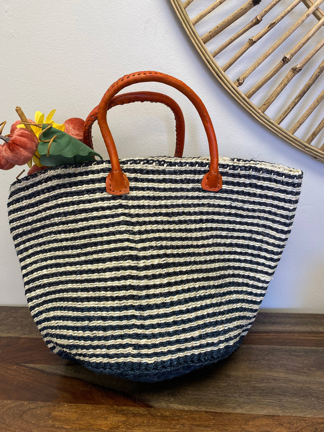 Multifunctional black and white striped woven tote bag used as picnic basket, weekender, or home decor.