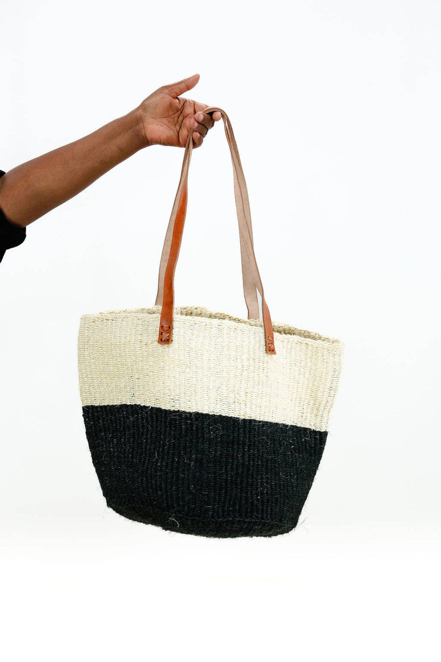 Black and white striped woven tote bag with leather shoulder straps, handcrafted in Kenya.