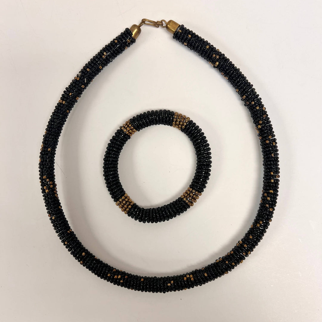 Handmade black beaded Maasai bracelet with matching necklace in traditional bead design.
