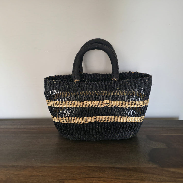 Ethically made African clutch bag handwoven from sustainable vetiver grass with stylish leather accents.