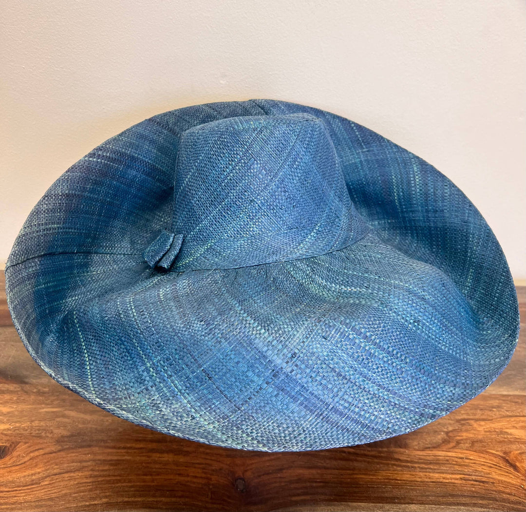 Eco-friendly raffia grass hat for sun protection and travel.