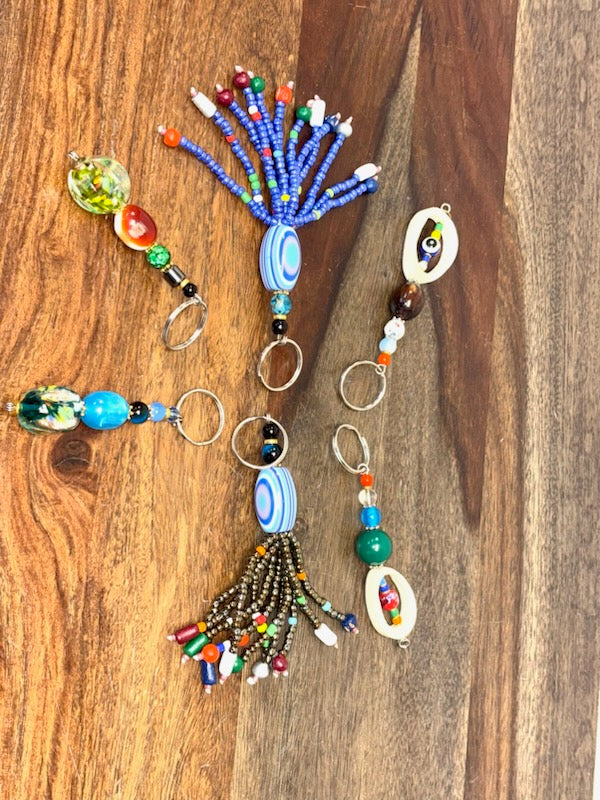 Colorful beaded keychains on a wooden surface