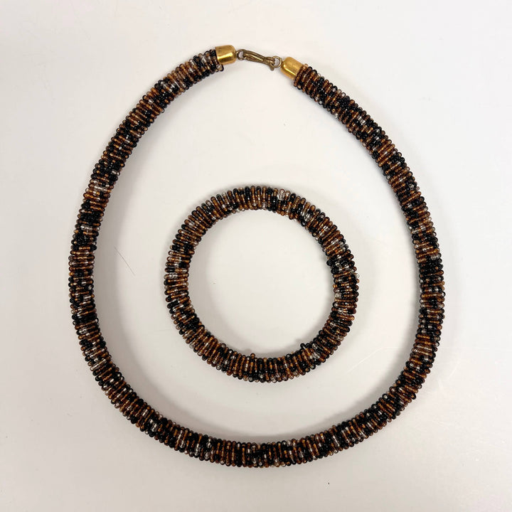 Brown and black beaded fair trade jewelry set from Kenya shown against neutral background.