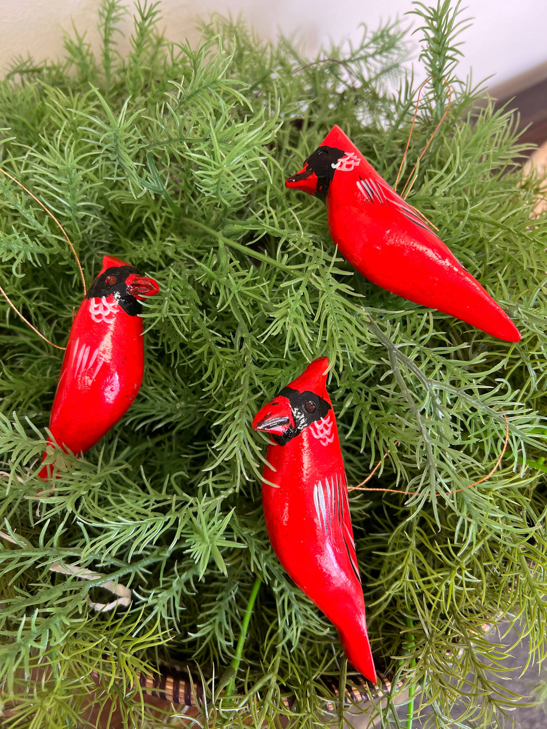 Sustainable fair trade wooden bird ornament, hand-painted and carved, perfect for Christmas tree or seasonal decorations.