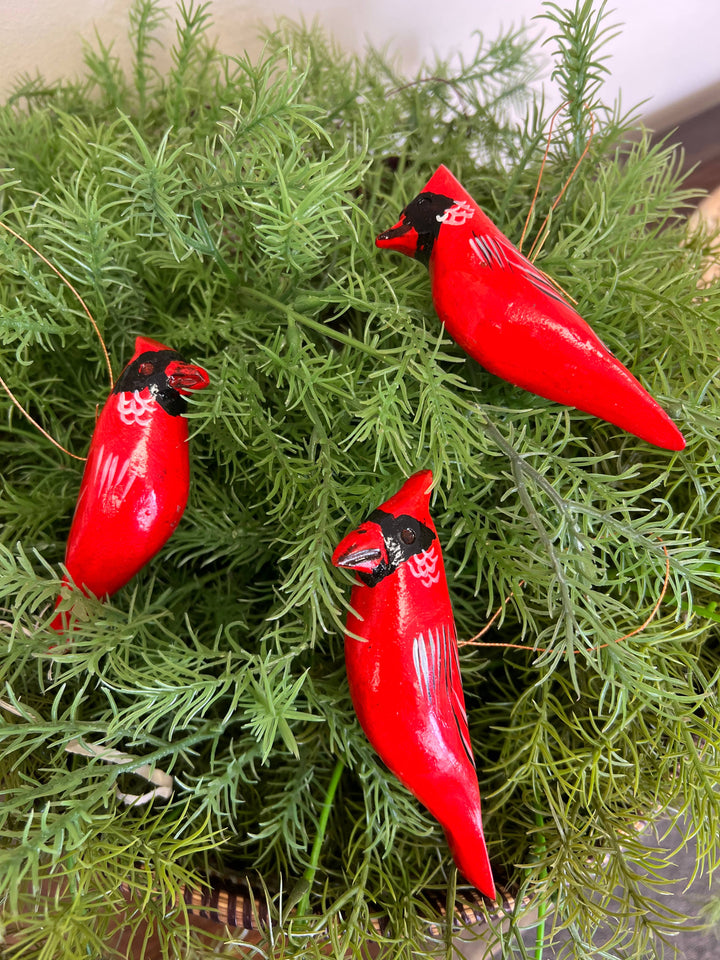 Sustainable fair trade wooden bird ornament, hand-painted and carved, perfect for Christmas tree or seasonal decorations.