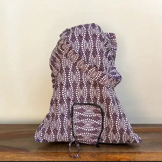 Flat-bottomed fabric shopping tote in vibrant African fabric patterns.