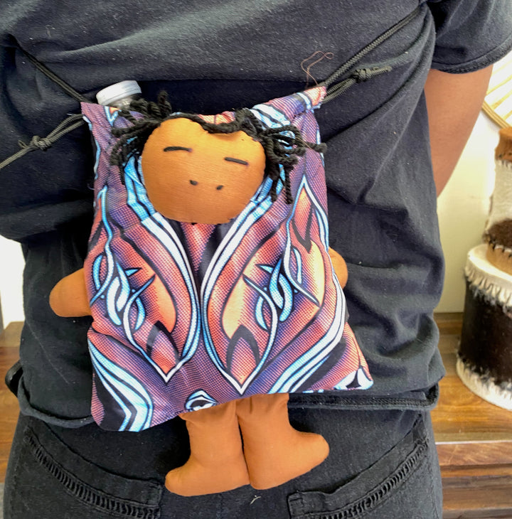 Ethically made doll purse with adjustable strap and colorful doll detail, supporting fair trade artisans.