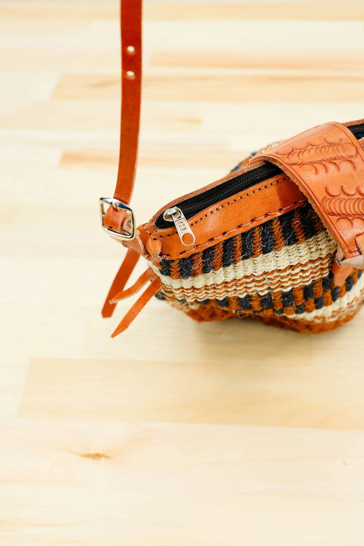 Small fair trade purse with leather trim and secure closure.