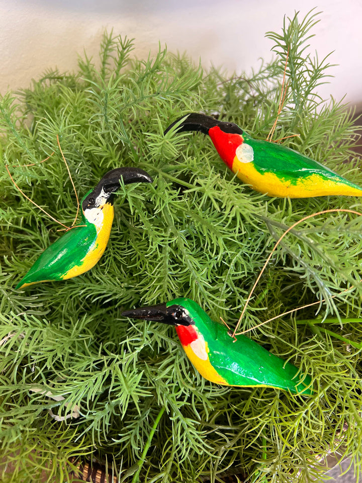 Eco-friendly hand-carved wooden bird ornament, vibrant hand-painted design supporting global artisans through fair trade.