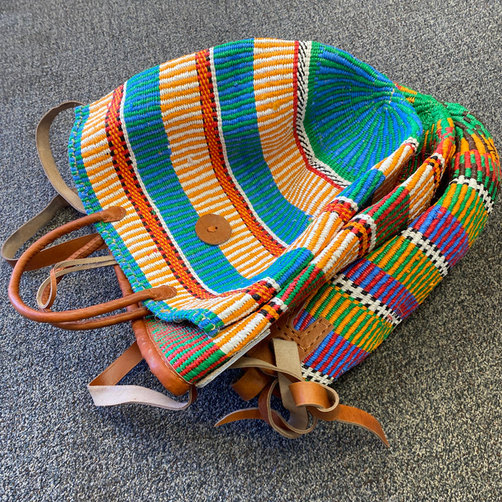 Kenyan handwoven totes with sustainable materials and leather trim, available in two handle styles.