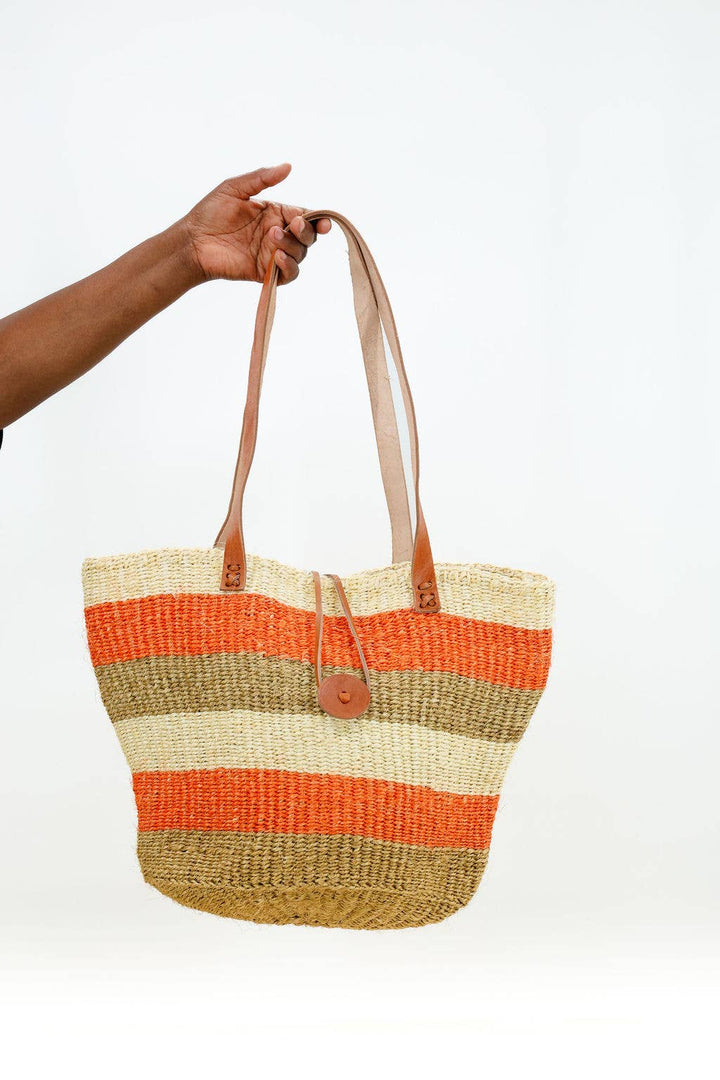Bright striped sisal tote bag with button closure and sustainable leather handles.