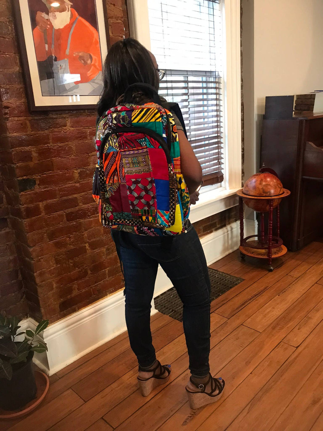 Colorful patchwork backpack made from recycled fabric scraps in Kenya, featuring fair trade craftsmanship, secure zipper, and sustainable storage for everyday use.