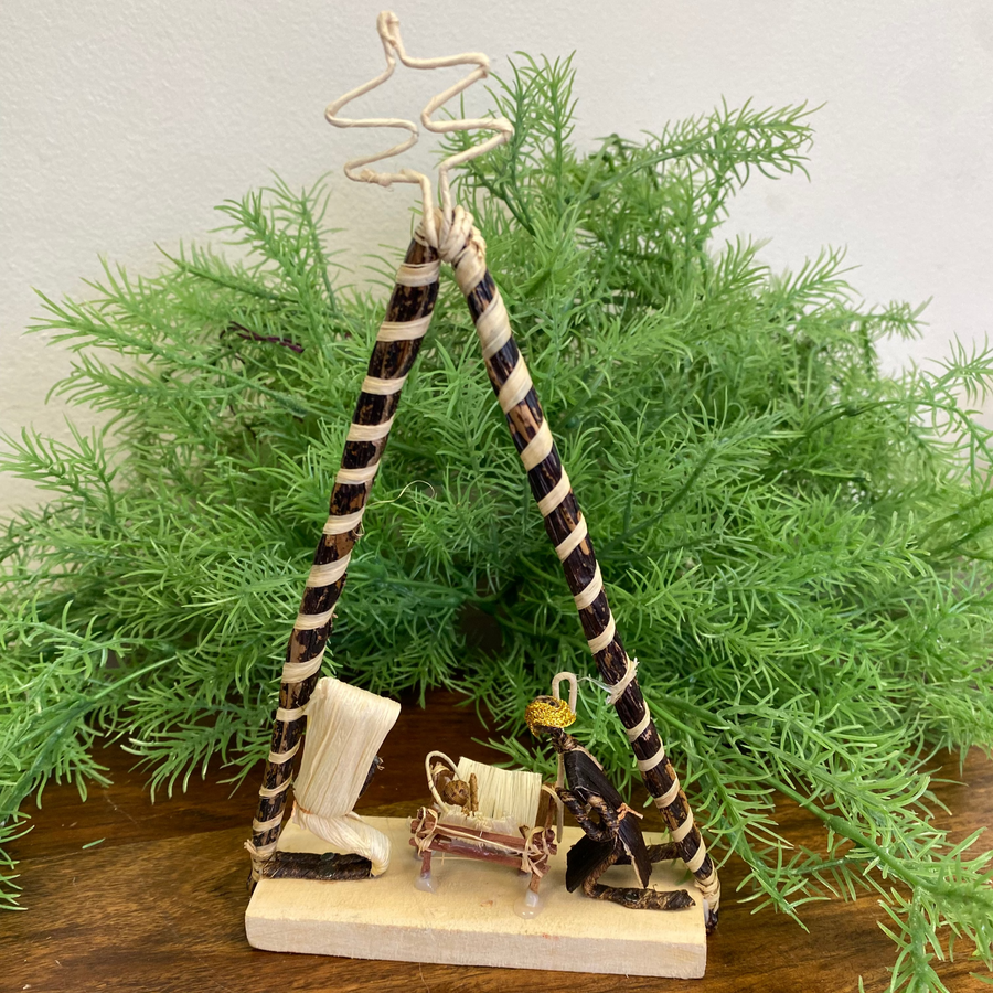 Handmade fair trade nativity scene from Kenya crafted from banana leaves on wood base.