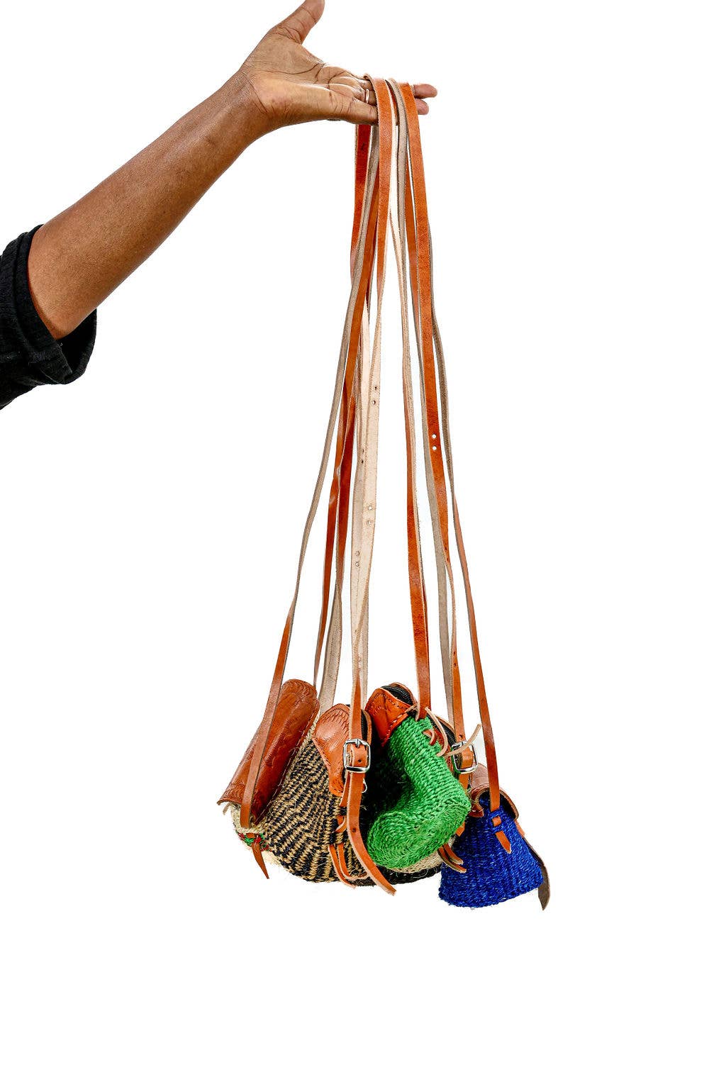 Fair trade sisal crossbody purse with leather strap and flap.