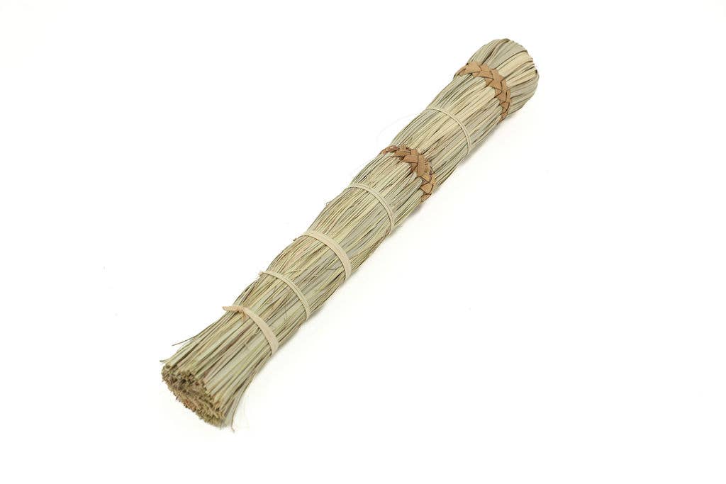 Eco-friendly mini broom made from sustainable palm leaves, perfect for cleaning or floral arrangements.