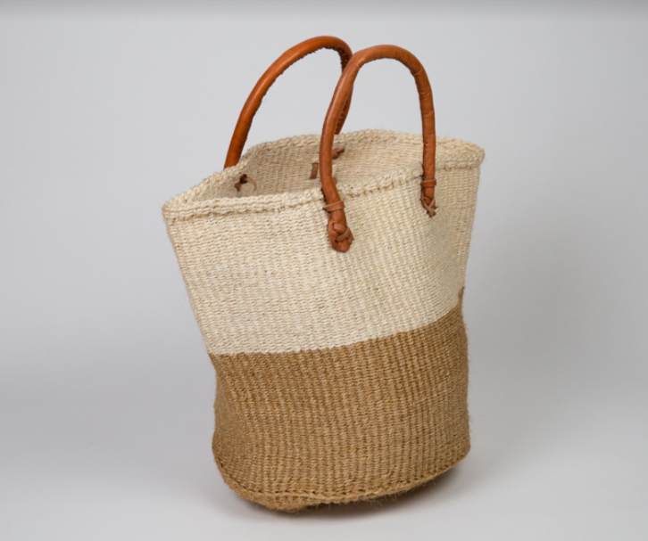 Fair trade natural woven tote in neutral colors with sustainable leather handles.