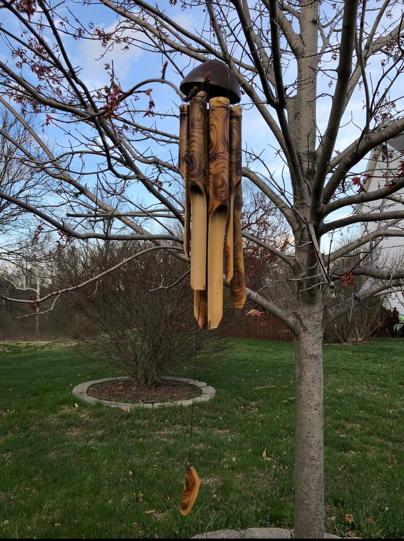 Eco-friendly bamboo wind chime producing soothing natural sounds that's perfect for your porch or anywhere outside.