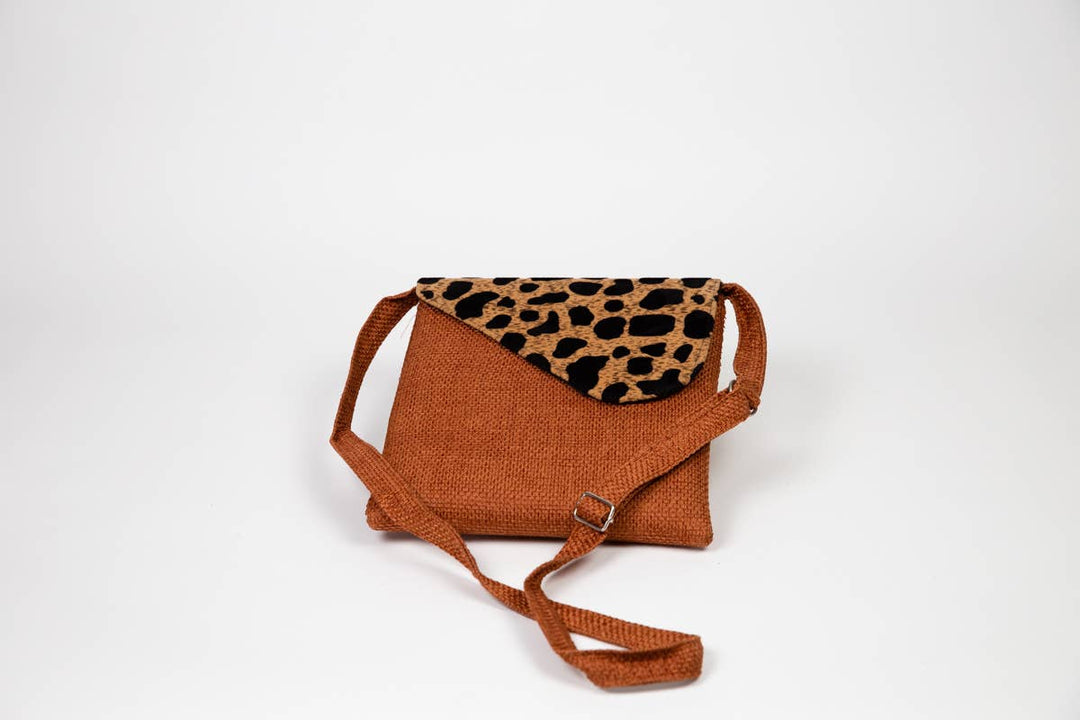 Assorted fair trade crossbody bags in colorful African prints.