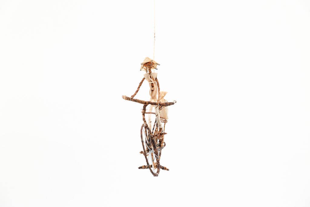 Handmade African cyclist figurine made from sustainable banana leaves and wire, fair trade artisan decor.
