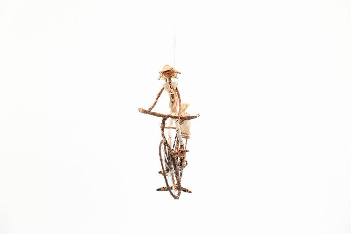 Handmade African cyclist figurine made from sustainable banana leaves and wire, fair trade artisan decor.