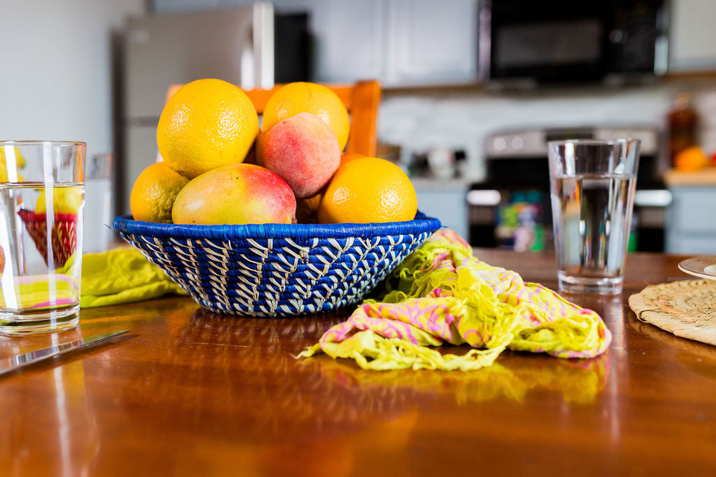 Handwoven fair trade African raffia fruit bowl made from natural fiber  by skilled artisans, perfect for kitchen or tabletop decor.