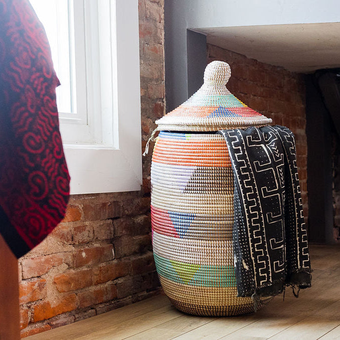 Fair trade lidded sweetgrass hamper woven with repurposed plastic in colorful patterns.