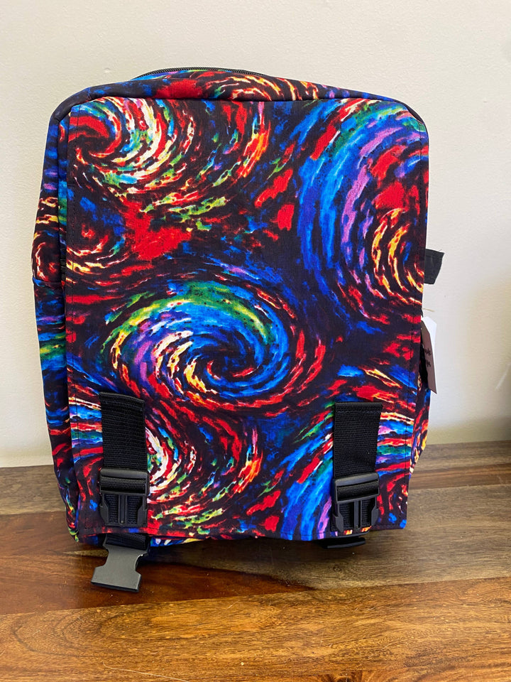Ethical fashion backpack with Kenyan craftsmanship, recycled fabric, and bold patchwork style, perfect for zero-waste lifestyles.