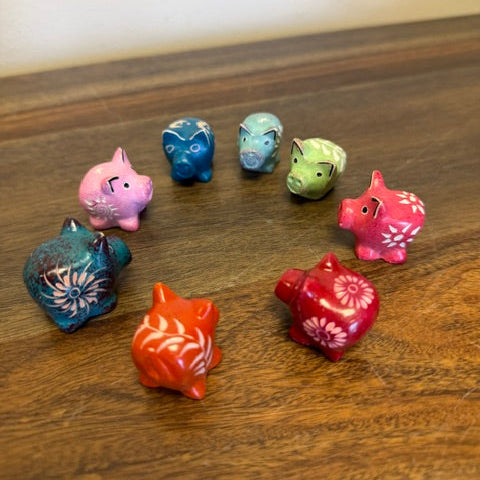 Kisii stone pig figurines in assorted dyed colors carved by artisans in Kenya
