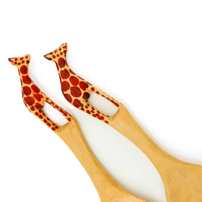 Fair trade wooden salad servers featuring hand-painted African giraffes.