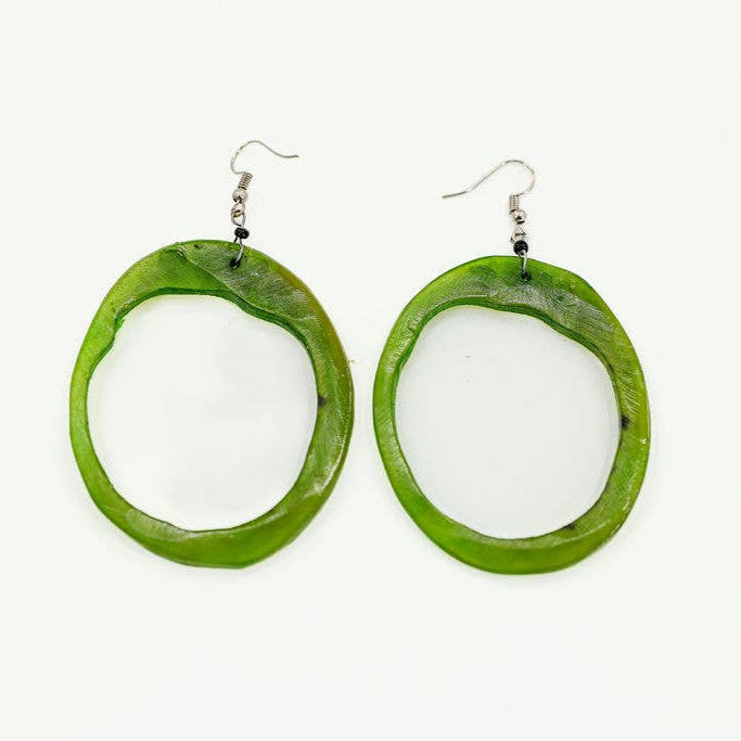 Fair trade earrings made from hand-carved recycled horn with natural grain patterns dyed green.