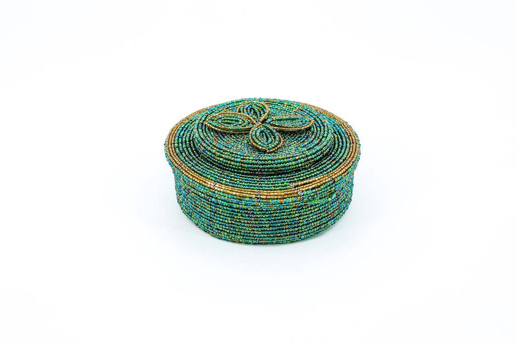 Colorful trinket holder used to store hair ties and bobby pins in a bathroom.