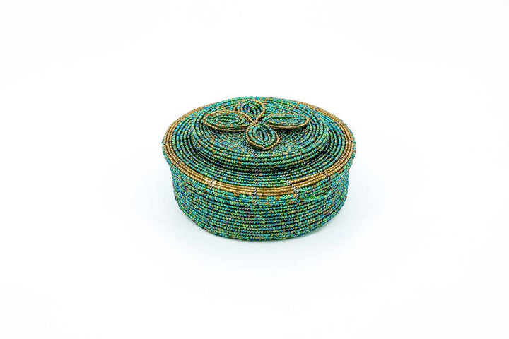 Colorful trinket holder used to store hair ties and bobby pins in a bathroom.