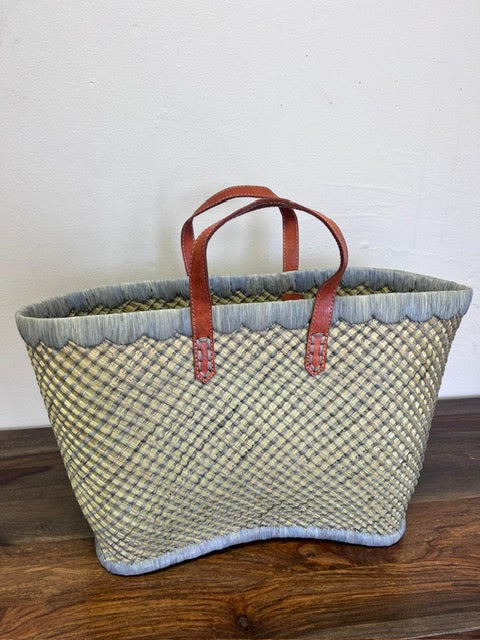 Grey tote for a relaxed day at the beach with a leather strap.