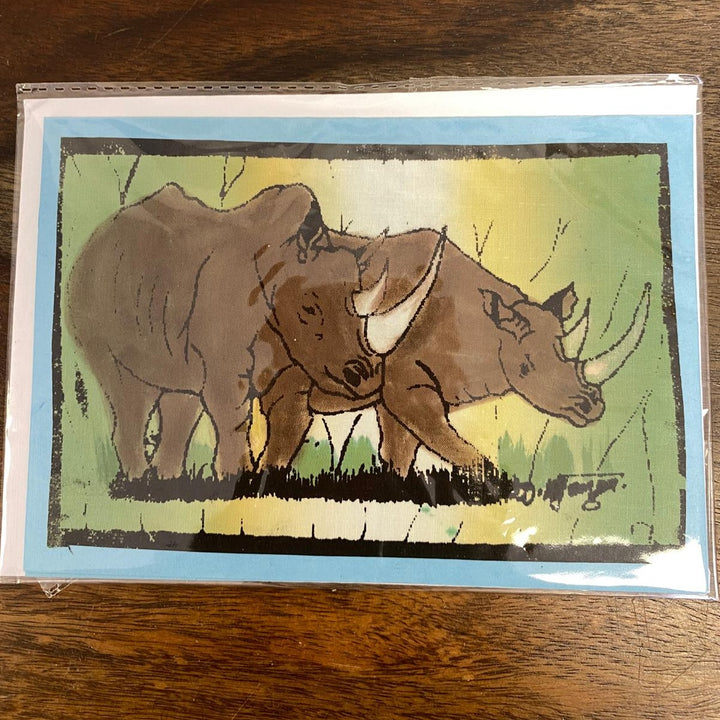 Card with illustration of two rhinos on a wooden surface. Card is blank inside, which makes it perfect for any occasion.