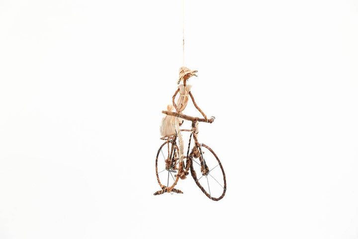 Solo bicyclist figurine wrapped in banana leaves and metal wire, fair trade home accent or gift idea.